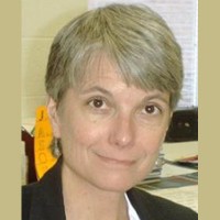 Christine Fisher Woman with a salt-and-pepper pixie cut